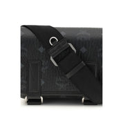 Close-up of MCM logo motif on black fabric shoulder bag