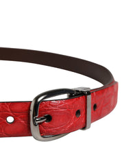Red leather dog collar with a silver buckle on a white background