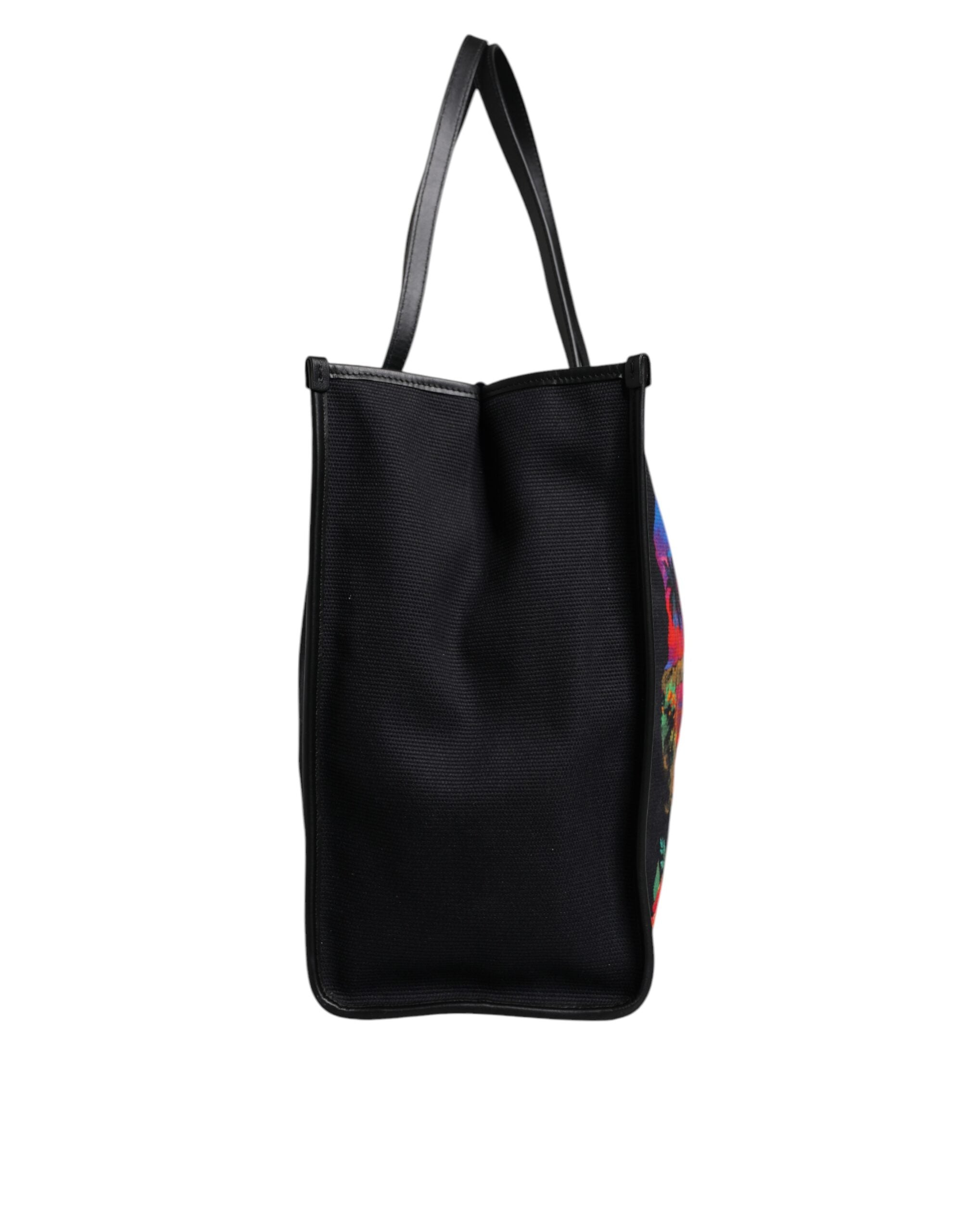 Shoppingväska med flerfärgat grafiskt tryck och handtag.