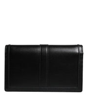 Svart läderhandväska i kalvskinn med kedjeband, för att bära över axeln eller som crossbody-väska.