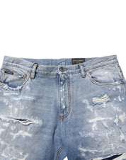 Blå slitna, slitna jeans