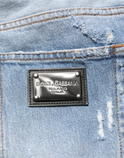 Blå slitna, slitna jeans