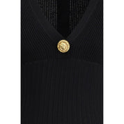 Svart miniklänning i viskos med knapp i lejonhuvud