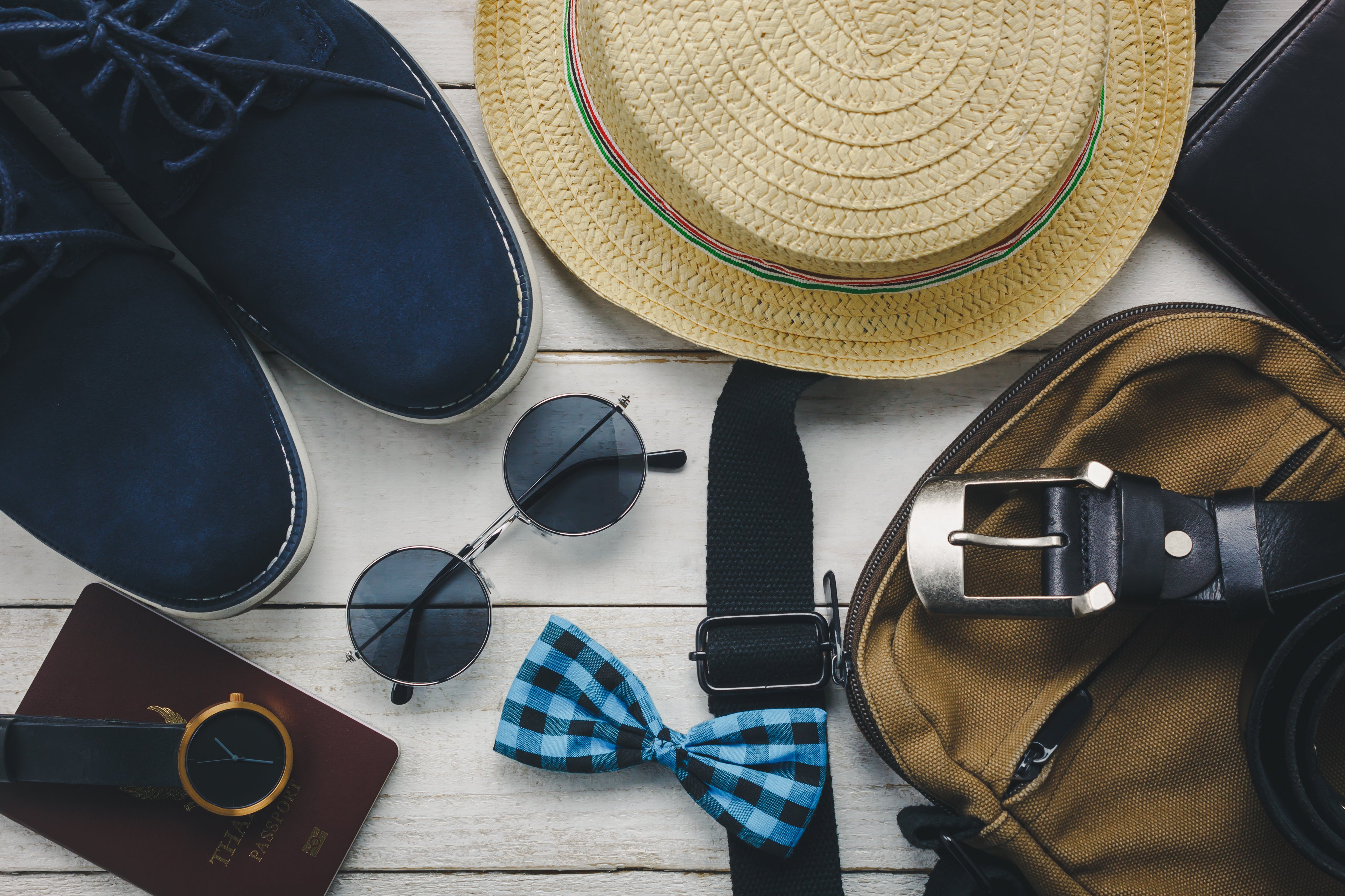 top-view-accessoires-travel-with-man-clothing-concept-bow-tie-wallet-wooden-background-watch-sunglasses-bag-hat-shoes-wood-table.jpg